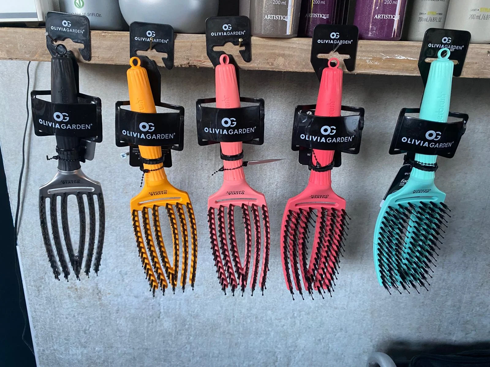 Olivia Garden borstels in verschillende kleuren aan een rek